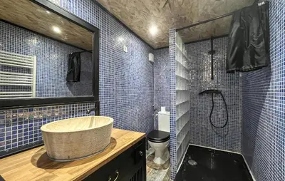 a bathroom with a sink and a shower with blue tiles at Awesome Home In Miramas With Swimming Pool in Miramas