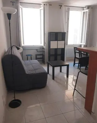 a living room with a couch and a table at Grand Studio Aix-En-Provence in Aix-en-Provence