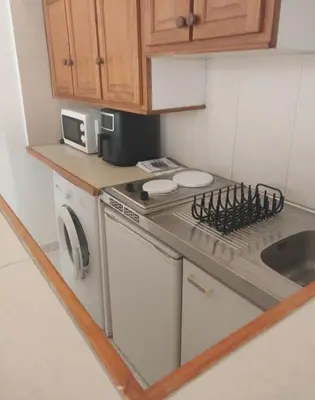 a small kitchen with a stove and a sink at Grand Studio Aix-En-Provence in Aix-en-Provence