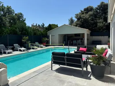 a swimming pool with a slide in front of a house at Charmante Maisonnette T3 avec Jardin Privé in La Motte-dʼAigues