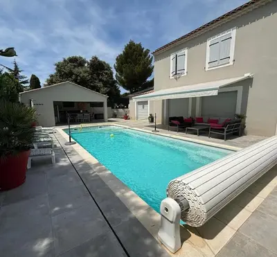 a bedroom with a bed and a wooden cabinet at Charmante Maisonnette T3 avec Jardin Privé in La Motte-dʼAigues