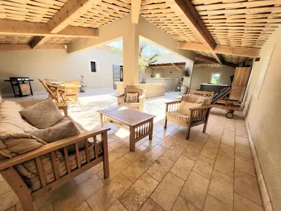 a living room with a couch and chairs and a tv at La propriété de Nans in Grans
