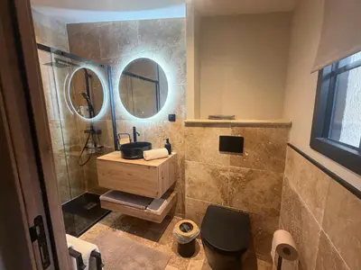 a bathroom with a sink and a mirror at Charmant appartement T2 cosy avec piscine in Mollégès
