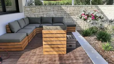 a couch sitting on top of a wooden deck at Villa 5 étoiles, 6 personnes in LʼIsle-sur-la-Sorgue