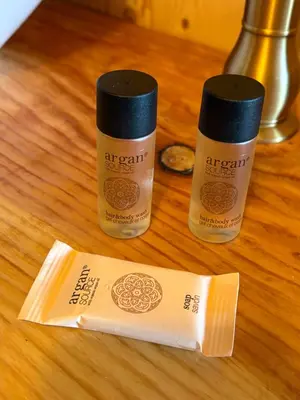 two bottles of hair products sitting on a table at Chicken roulotte des 3 cèdres in Cavaillon