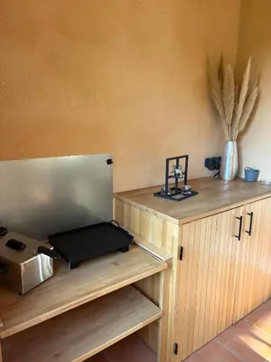 a kitchen with a counter with a microwave and a table at Appartement domaine de Pont Royal in Mallemort