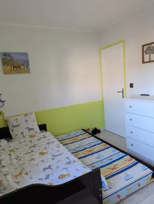 a bedroom with a bed and a white dresser at Maison 3 pièces avec jardin et terrasse in La Fare-les-Oliviers