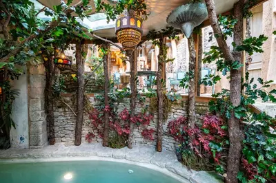a pool in a building with flowers and trees at Signature Home Pool & Panoramic Terrace in Goult