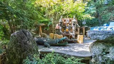 a garden with a iguana statue and a house at Signature Home Pool & Panoramic Terrace in Goult