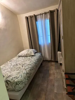 a small bedroom with a bed and a window at Appartement Lotus Rouge, 2 chambres, proche Mairie in Aix-en-Provence