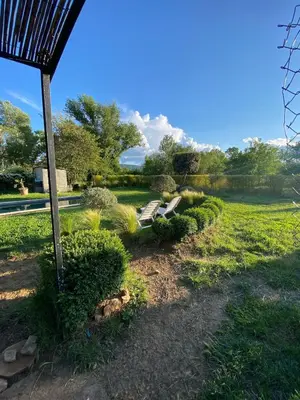a park with a bench in the grass at La Roussillonnaise in Roussillon