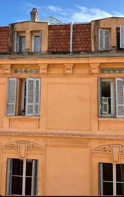 an orange building with windows and a roof at T2 spacieux en hyper centre pour 1 à 5 personnes in Aix-en-Provence