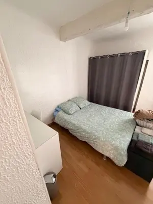 a small bedroom with a bed and a window at T2 spacieux en hyper centre pour 1 à 5 personnes in Aix-en-Provence