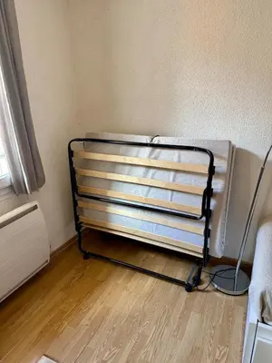 a bed frame in a corner of a room at T2 spacieux en hyper centre pour 1 à 5 personnes in Aix-en-Provence