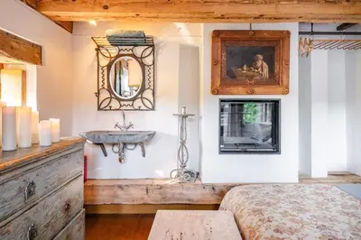a bedroom with a sink and a bed and a mirror at Romantic Provence Pool & Mill View in Goult