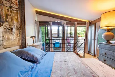 a bedroom with a large bed and a window at Romantic Provence Pool & Mill View in Goult