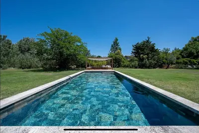 a swimming pool in a yard with a gazebo at mas de la bergerie in Cavaillon