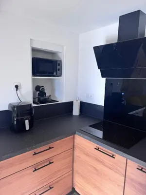 a kitchen with a microwave and a counter top at Studio Rénové de Charme en Provence in Caumont-sur-Durance