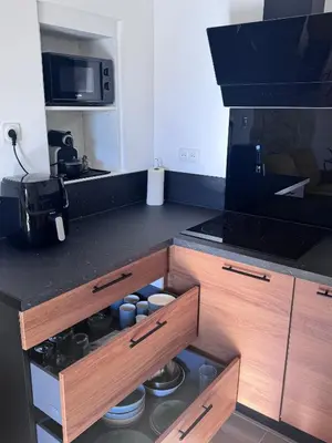 a kitchen with a stove and a counter top at Studio Rénové de Charme en Provence in Caumont-sur-Durance