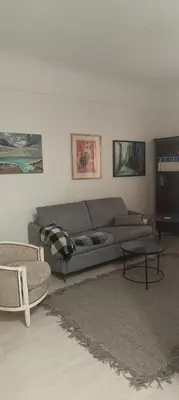 a living room with a couch and a table at T2 calme centre Aix Clim Fibre in Aix-en-Provence