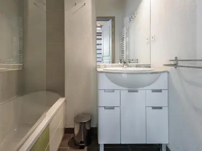 a white bathroom with a sink and a shower at D du Ventoux D N55 3P6 in Aubignan