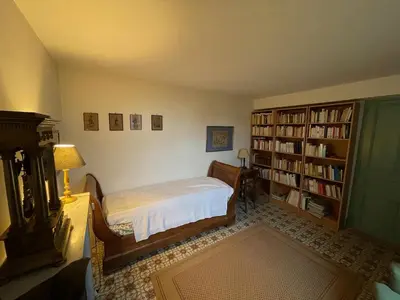 a bedroom with a bed and a book shelf at Pierre Jacques' House in Caromb