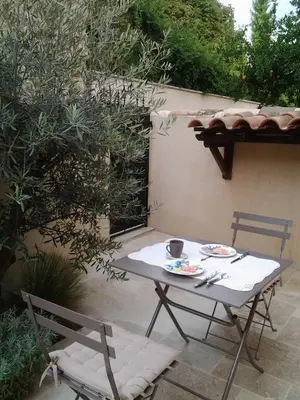 a table and chairs sitting on a patio at Mas De Hameau in Oppède