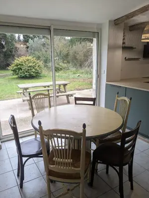 a table and chairs in a kitchen with a window at Le gîte du domaine de Sinaca Villa in Sénas