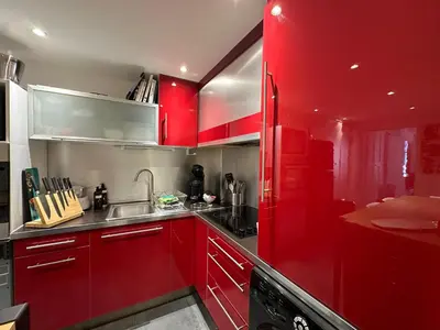 a red kitchen with a sink and a red refrigerator at Chez Anne - Appartement cosy avec mezzanine au cœur du centre historique d'Aix-en-Provence in Aix-en-Provence