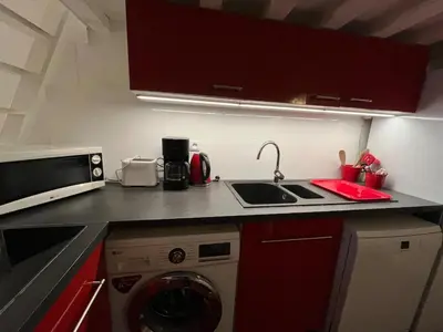 a kitchen with a sink and a washing machine at Joli appartement atypique dans le centre d'Aix in Aix-en-Provence
