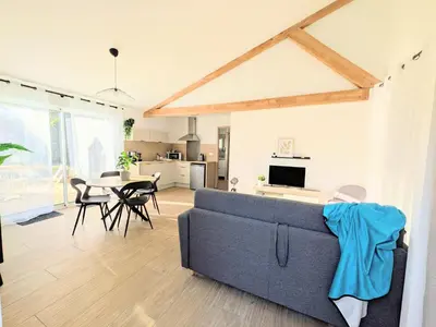 a dining room with a table and chairs at À l'ombre du pin in Entraigues-sur-la-Sorgue
