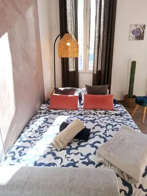 a bedroom with a bed with a blue and white pattern at Grand studio dans le centre historique in Aix-en-Provence