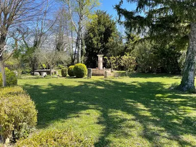 a park with a grave yard with trees and grass at Les Oliviers- Bed and Breakfast in Velleron