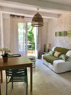 a living room with a couch and a table at Les Oliviers- Bed and Breakfast in Velleron