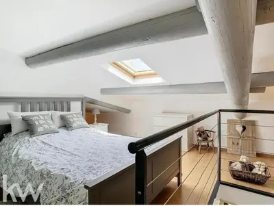 a bedroom with a bed and a skylight at Le cabanon in Saint-Martin-de-Castillon