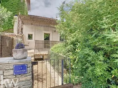 a gate in front of a house with trees at Le cabanon in Saint-Martin-de-Castillon
