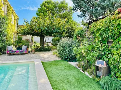 a backyard with a swimming pool and a garden at Havre de paix proche centre ville, jardin, piscine in LʼIsle-sur-la-Sorgue