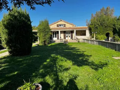 a house with a large yard with a tree at Villa Papillon in Monteux