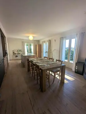a dining room with a table and chairs in a kitchen at Villa Papillon in Monteux