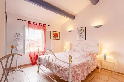 a bedroom with a bed and a window at Les gites de Bel-Air en Luberon in Les Taillades