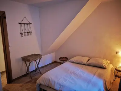 a bedroom with a bed and a table in it at Petit mas en Provence in Cornillon-Confoux