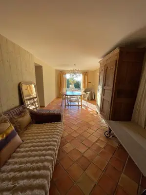 a living room with a couch and a table at La Maison du village in Pierrevert