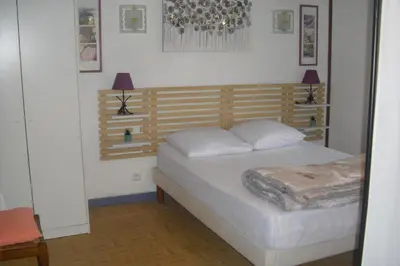 a bedroom with a bed with two pillows on it at Lou mas li Pitchoun 