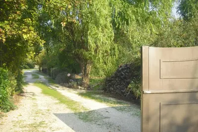 a gate on a road next to a tree at Lou mas li Pitchoun 