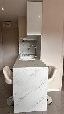a kitchen with a white counter with a sink at Slux Studio 399 in Aix-en-Provence