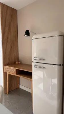 a refrigerator in a kitchen with a wooden desk at Slux Studio 399 in Aix-en-Provence