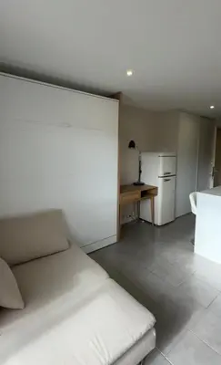 a room with a bed and a table and a refrigerator at Slux Studio 399 in Aix-en-Provence