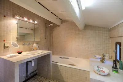 a bathroom with a sink and a bath tub at Mas des Côtes in Saint-Hippolyte-le-Graveyron