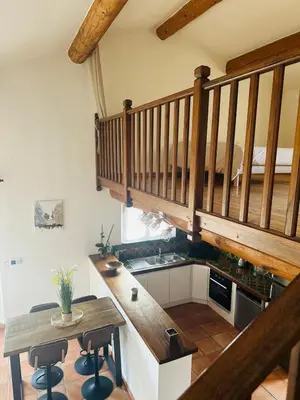 a couch in a living room with a table at VILLA DE LA ROQUE II - Loft in Eygalières