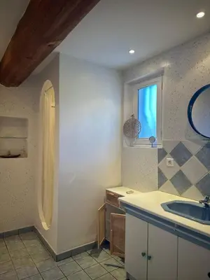 a bathroom with a sink and a window at VILLA DE LA ROQUE II - Loft in Eygalières